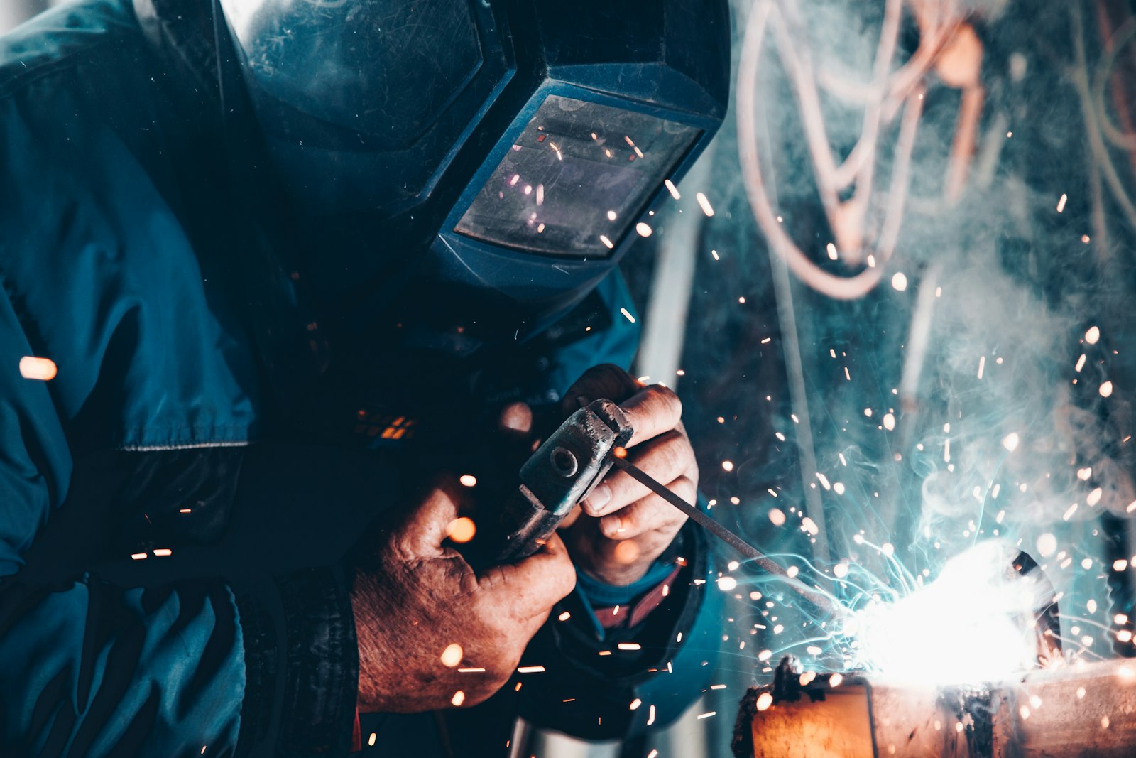 Electrician at work with bright sparks in an industrial setting