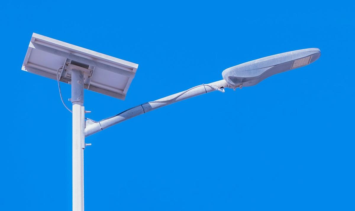 Solar-powered LED street light against a clear blue sky